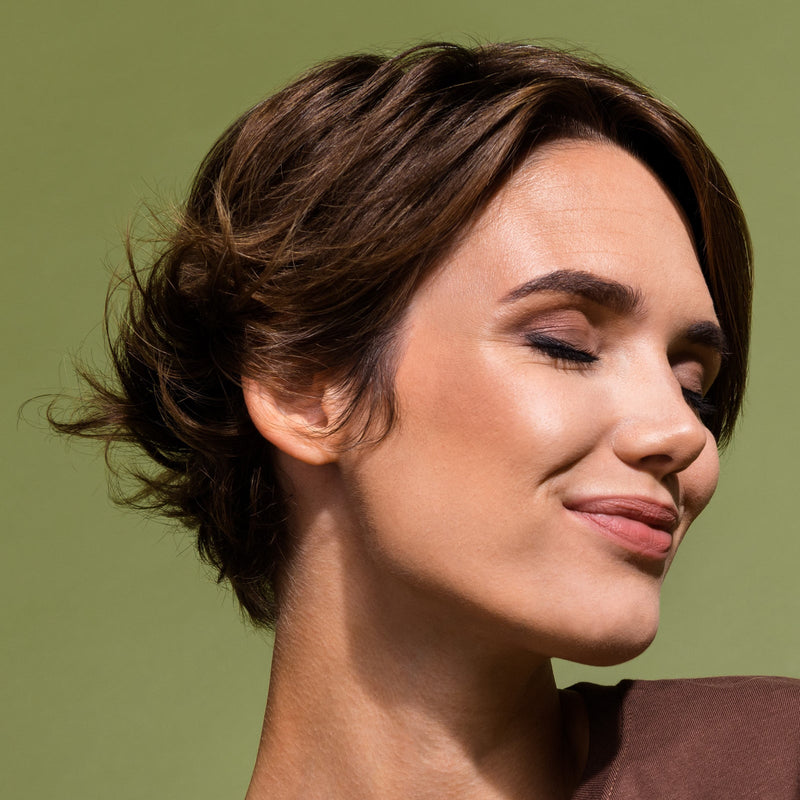 Woman with glossy brunette hair catching the light